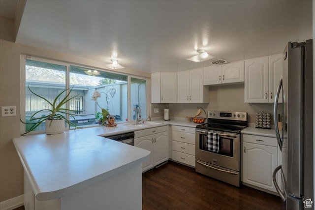 4879 S 1690 E, Holladay, UT 84117 - kitchen with stainless steel appliances, a peninsula, white cabinetry, and dark wood-style floors