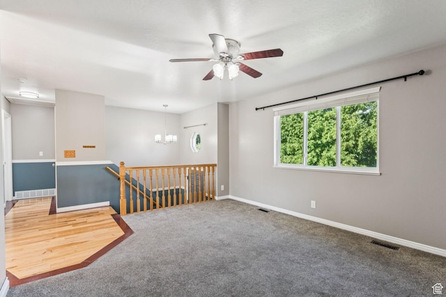 786 S Lindon Ct W, Logan, UT 84321 - carpeted empty room with ceiling fan and a chandelier