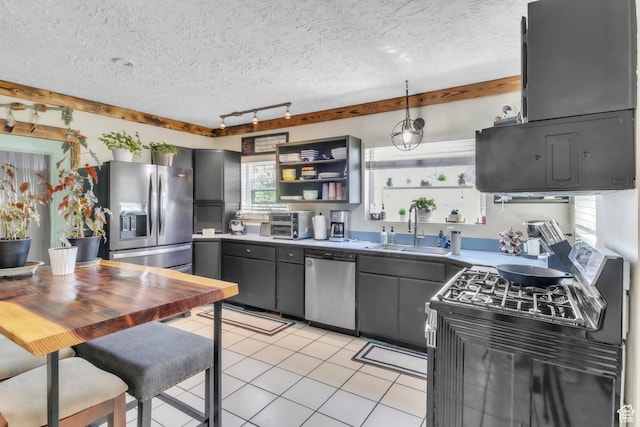 586 W 300 N, Fountain Green, UT 84632 - kitchen with appliances with stainless steel finishes, open shelves, rail lighting, light tile patterned floors, and a textured ceiling