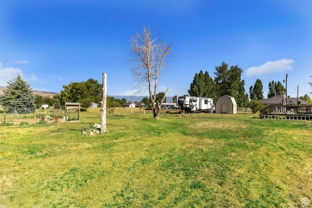 586 W 300 N, Fountain Green, UT 84632 - view of grassy yard featuring a storage unit and a wooden deck