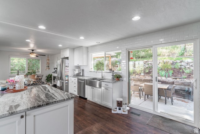 2582 Jacqueline Dr E, Ogden, UT 84403 - kitchen featuring stainless steel appliances, dark wood finished floors, white cabinetry, light stone countertops, and a ceiling fan