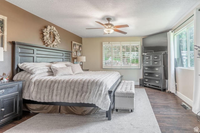 2582 Jacqueline Dr E, Ogden, UT 84403 - bedroom featuring dark wood-style floors, a textured ceiling, and a ceiling fan