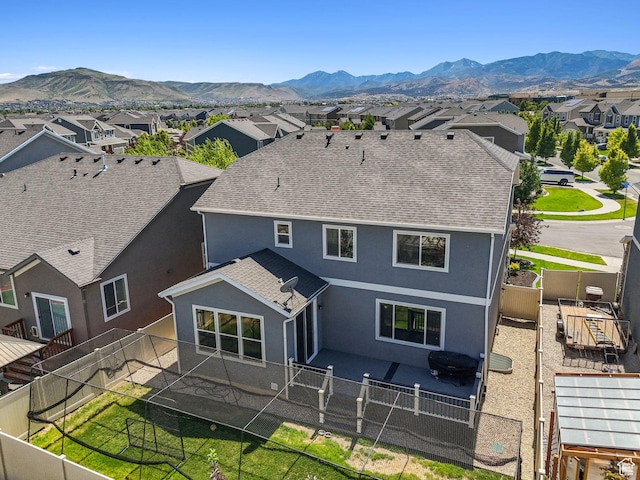 5488 W Tower Arch Ln, Herriman, UT 84096 - back of property with a residential view, stucco siding, roof with shingles, a fenced backyard, and a mountain view