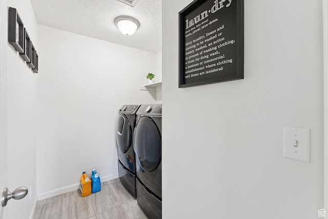5488 W Tower Arch Ln, Herriman, UT 84096 - laundry room with separate washer and dryer, wood finished floors, and a textured ceiling