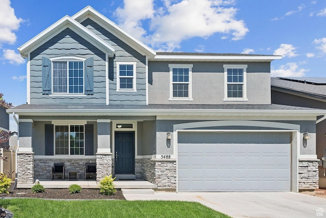 5488 W Tower Arch Ln, Herriman, UT 84096 - craftsman-style home featuring stone siding, covered porch, driveway, and stucco siding