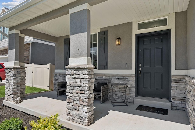 5488 W Tower Arch Ln, Herriman, UT 84096 - view of exterior entry featuring stone siding and a porch