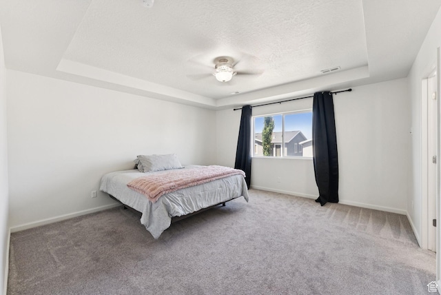 5488 W Tower Arch Ln, Herriman, UT 84096 - carpeted bedroom featuring a tray ceiling, a textured ceiling, and a ceiling fan