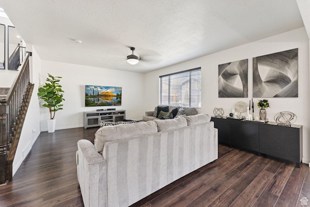 5488 W Tower Arch Ln, Herriman, UT 84096 - living room featuring dark wood-type flooring, ceiling fan, stairs, and a textured ceiling