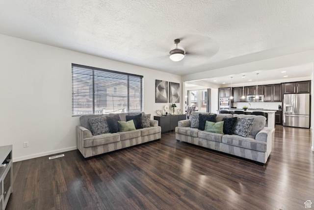 5488 W Tower Arch Ln, Herriman, UT 84096 - living area with ceiling fan, dark wood-style flooring, a textured ceiling, and recessed lighting