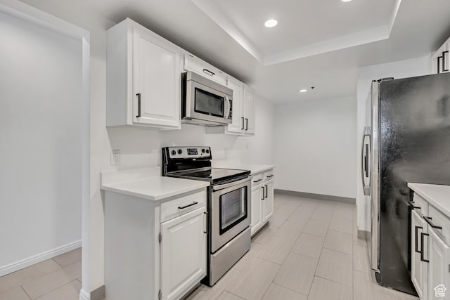 48 W 300 S Unit 903, Salt Lake City, UT 84101 - kitchen featuring appliances with stainless steel finishes, light countertops, recessed lighting, white cabinetry, and a tray ceiling