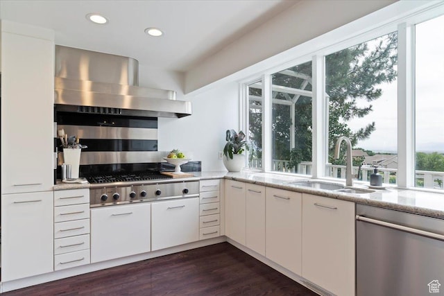 1074 E Raymond Rd, Fruit Heights, UT 84037 - kitchen with stainless steel appliances, wall chimney range hood, light stone counters, recessed lighting, and white cabinets