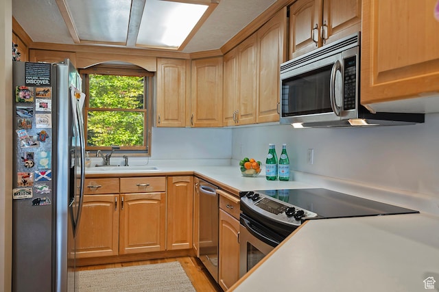 8216 S Scandia Way, Sandy, UT 84093 - kitchen featuring appliances with stainless steel finishes, light countertops, and light wood-type flooring
