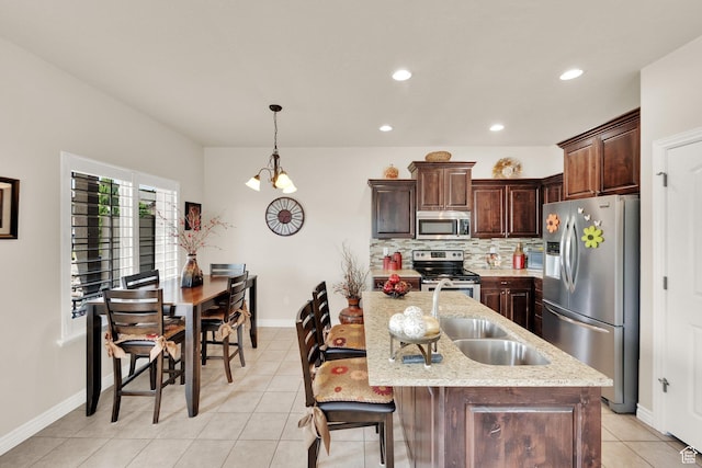 3951 W Sage Blossom Way S, Jordan, UT 84009 - kitchen with stainless steel appliances, light tile patterned floors, recessed lighting, decorative backsplash, and dark brown cabinets