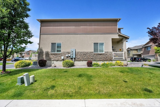 3951 W Sage Blossom Way S, Jordan, UT 84009 - view of property exterior featuring stucco siding, stone siding, and a yard