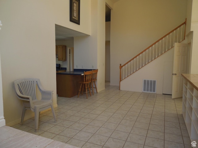 426 N Amber Ln N Unit 426, Castle Valley, UT 84532 - living area with stairs, a towering ceiling, and light tile patterned floors