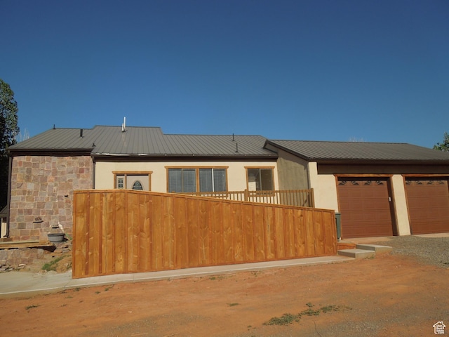 426 N Amber Ln N Unit 426, Castle Valley, UT 84532 - view of front of home with a metal roof, driveway, stucco siding, and stone siding
