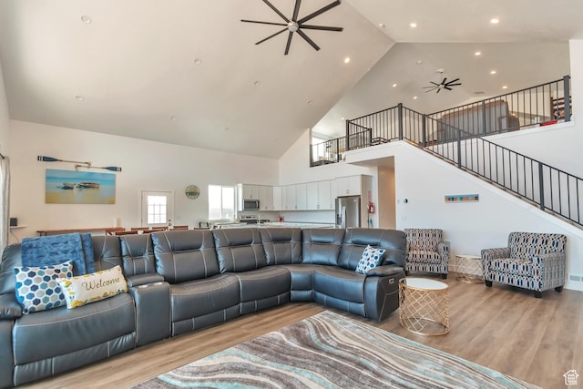248 W Chukar Cir Unit 18, Garden City, UT 84028 - living area featuring a ceiling fan, high vaulted ceiling, stairs, light wood finished floors, and recessed lighting