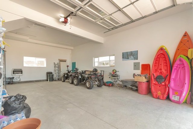 248 W Chukar Cir Unit 18, Garden City, UT 84028 - garage featuring electric panel, heating unit, and a garage door opener