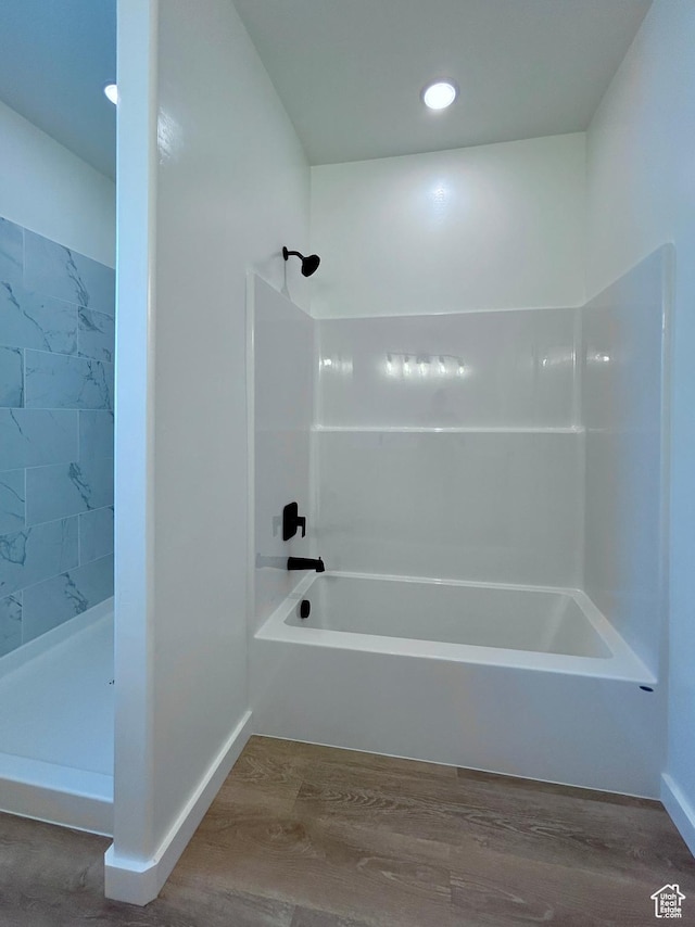 82 N 500 W, Gunnison, UT 84634 - bathroom featuring wood finished floors, washtub / shower combination, and recessed lighting