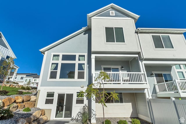 9757 N Aaron Ave E Unit 204, Eagle Mountain, UT 84005 - rear view of house with stucco siding and a balcony