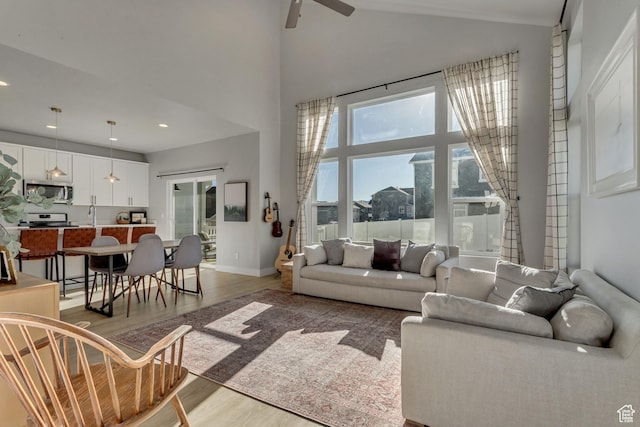 9757 N Aaron Ave E Unit 204, Eagle Mountain, UT 84005 - living room featuring light wood-style floors, a ceiling fan, a towering ceiling, and recessed lighting