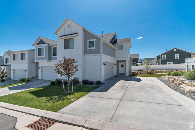 9757 N Aaron Ave E Unit 204, Eagle Mountain, UT 84005 - view of front of house with concrete driveway, an attached garage, board and batten siding, and a residential view