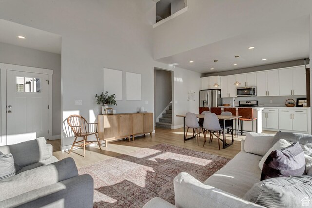 9757 N Aaron Ave E Unit 204, Eagle Mountain, UT 84005 - living room featuring light wood-type flooring, stairs, and recessed lighting