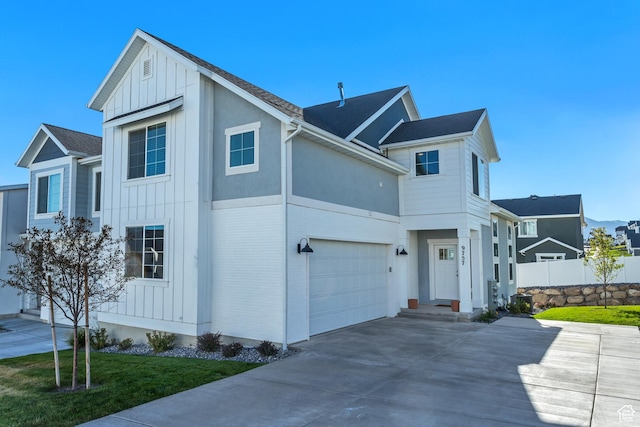 9757 N Aaron Ave E Unit 204, Eagle Mountain, UT 84005 - view of front of property with board and batten siding, an attached garage, and concrete driveway