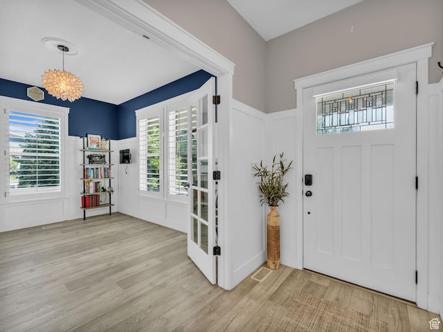 10298 S Otter Trail Dr, South Jordan, UT 84095 - entryway featuring light wood finished floors, a decorative wall, and wainscoting