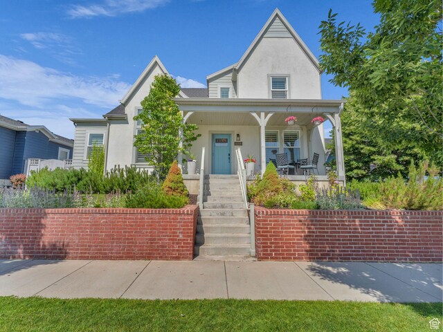 10298 S Otter Trail Dr, South Jordan, UT 84095 - view of front of house with stucco siding and a porch