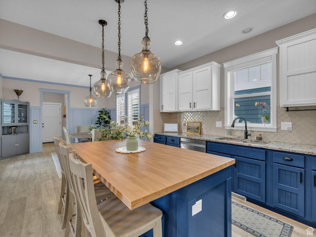 10298 S Otter Trail Dr, South Jordan, UT 84095 - kitchen featuring blue cabinets, white cabinets, butcher block countertops, backsplash, and dishwasher