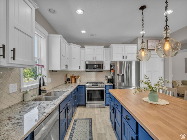 10298 S Otter Trail Dr, South Jordan, UT 84095 - kitchen with stainless steel appliances, blue cabinets, white cabinets, light wood-style flooring, and wooden counters