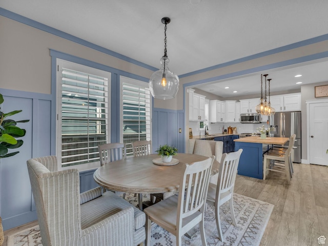 10298 S Otter Trail Dr, South Jordan, UT 84095 - dining room featuring a wainscoted wall, a decorative wall, light wood-style floors, and recessed lighting