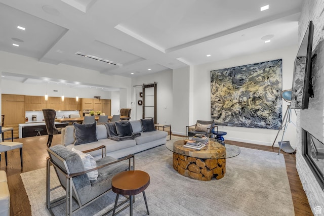 333 Main St Unit 10, Park City, UT 84060 - living area with a barn door, wood finished floors, a fireplace, recessed lighting, and beamed ceiling