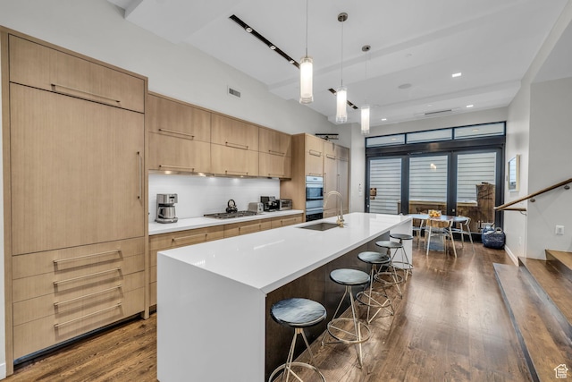 333 Main St Unit 10, Park City, UT 84060 - kitchen featuring dark wood finished floors, a breakfast bar area, light countertops, and a kitchen island with sink