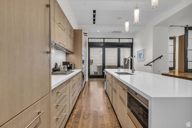 333 Main St Unit 10, Park City, UT 84060 - kitchen featuring appliances with stainless steel finishes, light countertops, light brown cabinetry, dark wood-style floors, and modern cabinets