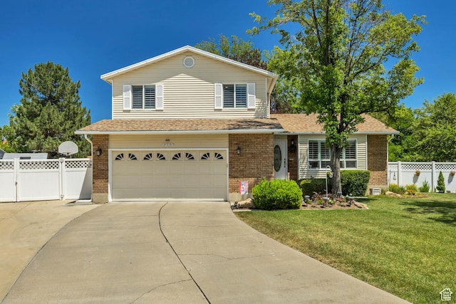 7305 S Autumn Meadow Cir W, West Jordan, UT 84084 - view of front of house featuring brick siding, an attached garage, and concrete driveway