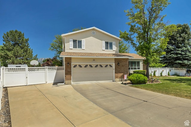 7305 S Autumn Meadow Cir W, West Jordan, UT 84084 - traditional home with brick siding, a gate, a garage, concrete driveway, and roof with shingles