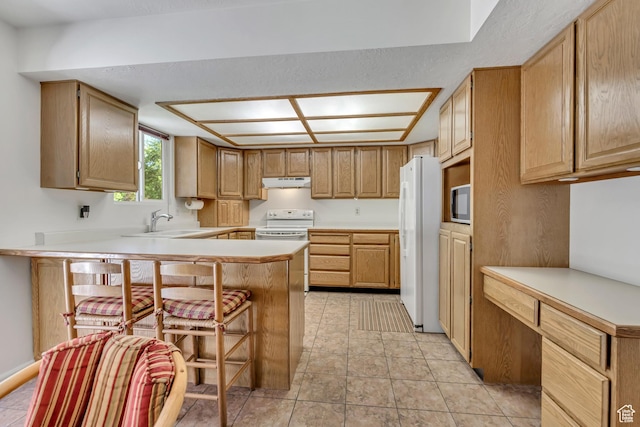 7305 S Autumn Meadow Cir W, West Jordan, UT 84084 - kitchen featuring a peninsula, white appliances, a breakfast bar area, light countertops, and under cabinet range hood