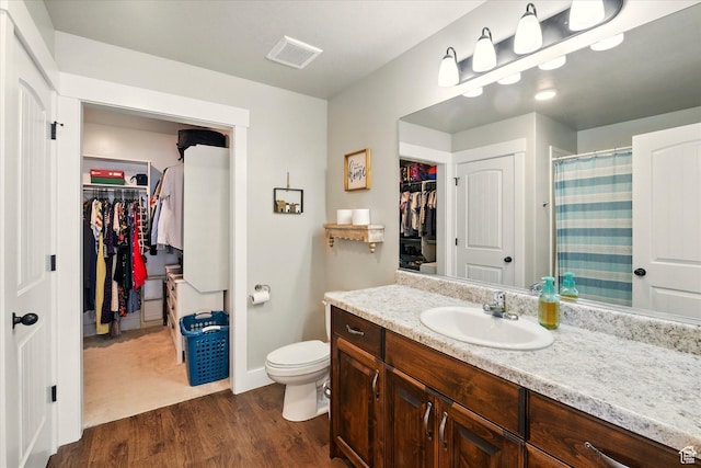 1469 W 2200 S, Wellsville, UT 84339 - full bathroom featuring a spacious closet, vanity, wood finished floors, and curtained shower