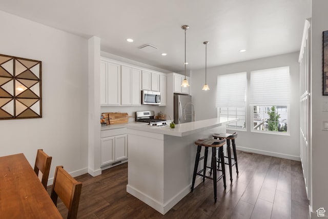5359 W Bowstring Way Unit 358, South Jordan, UT 84009 - kitchen with appliances with stainless steel finishes, dark wood-type flooring, white cabinets, and recessed lighting