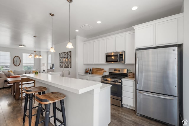 5359 W Bowstring Way Unit 358, South Jordan, UT 84009 - kitchen with stainless steel appliances, dark wood-type flooring, white cabinets, a kitchen island, and open floor plan