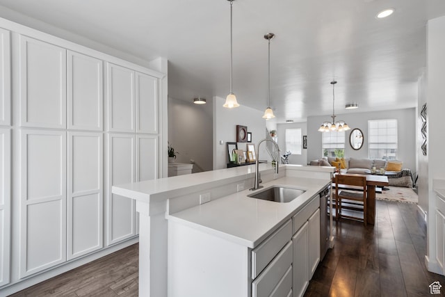 5359 W Bowstring Way Unit 358, South Jordan, UT 84009 - kitchen with dark wood-type flooring, light countertops, dishwasher, open floor plan, and a chandelier