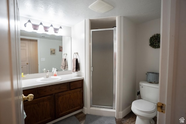 1075 E 2600 N, North Ogden, UT 84414 - bathroom featuring vanity, a stall shower, wood finished floors, and a textured ceiling