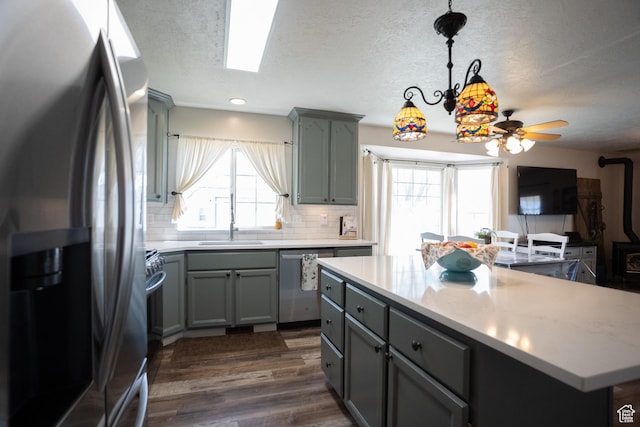 1075 E 2600 N, North Ogden, UT 84414 - kitchen featuring stainless steel appliances, gray cabinets, plenty of natural light, a textured ceiling, and recessed lighting