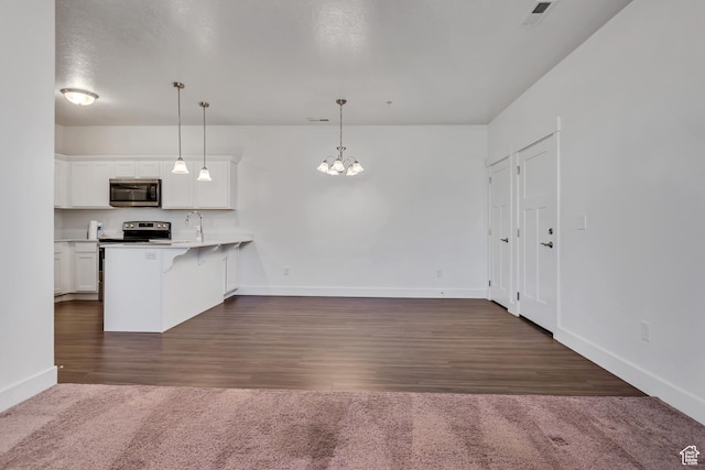 776 N 260 W, Vineyard, UT 84059 - kitchen with appliances with stainless steel finishes, a kitchen breakfast bar, white cabinetry, a peninsula, and a chandelier