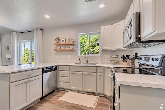442 N Cowan Cir E, Payson, UT 84651 - kitchen featuring appliances with stainless steel finishes, a peninsula, plenty of natural light, light countertops, and recessed lighting