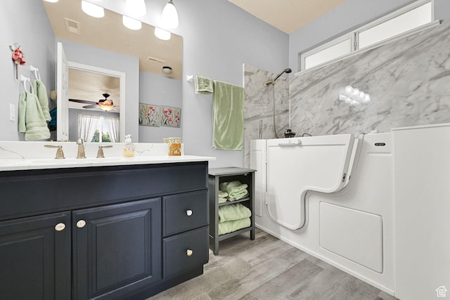 3139 N Pelican Dr, Farr West, UT 84404 - bathroom with a shower, wood finished floors, vanity, and a ceiling fan