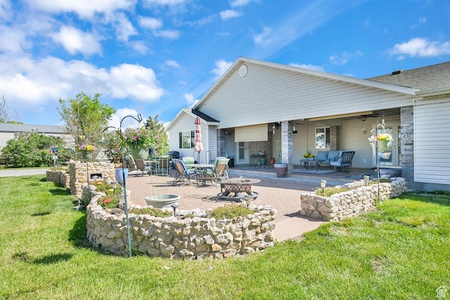 3139 N Pelican Dr, Farr West, UT 84404 - back of house featuring an outdoor fire pit, a patio, and a lawn