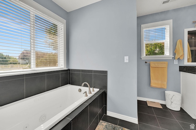 3139 N Pelican Dr, Farr West, UT 84404 - bathroom featuring a jetted tub, tile patterned floors, and vanity